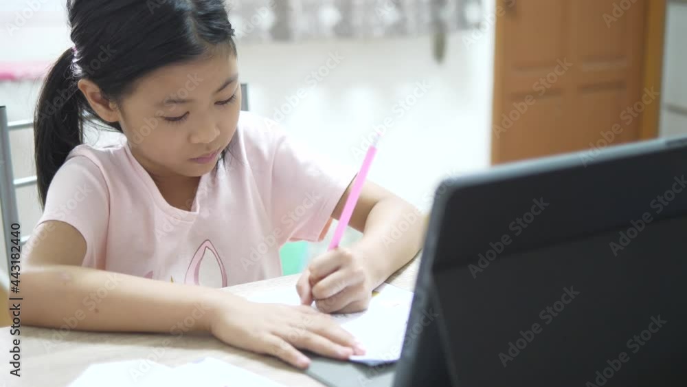 Selective focus of happy kid online studying near laptop at home Selective focus of happy kid online studying near laptop at home