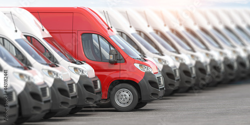 Obraz na plátně Red delivery van in a row of white vans