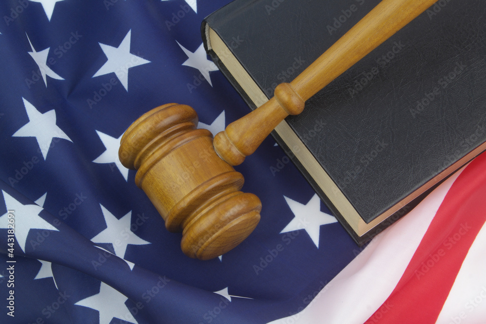 Legal book and judge gavel on USA flag. Laws and court of United States concept.	