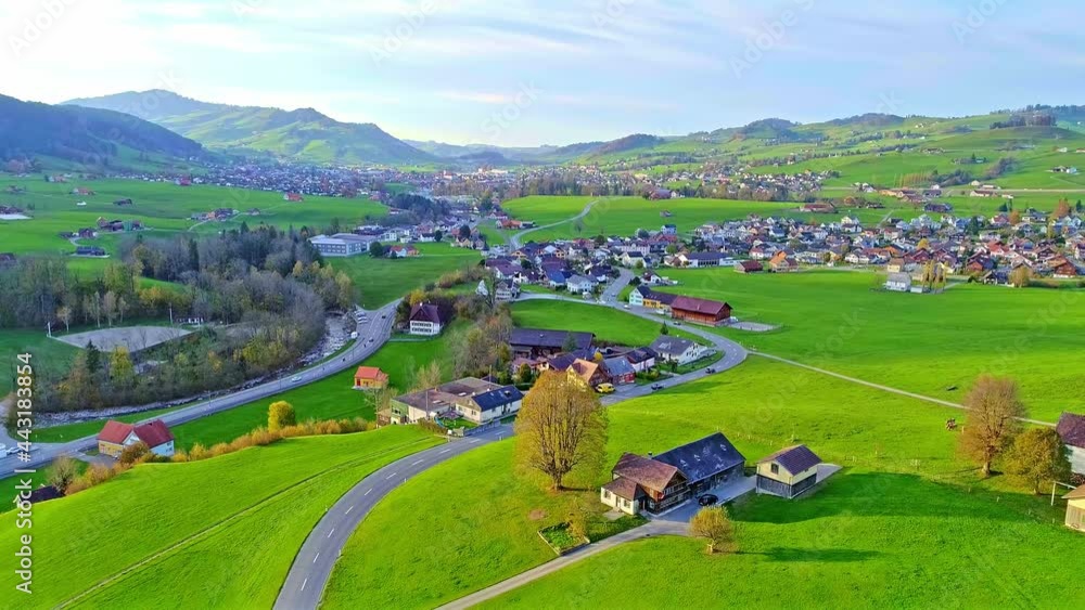 Aerial view of charming Swiss town, vehicles driving on the road Aerial view of charming Swiss town, vehicles driving on the road