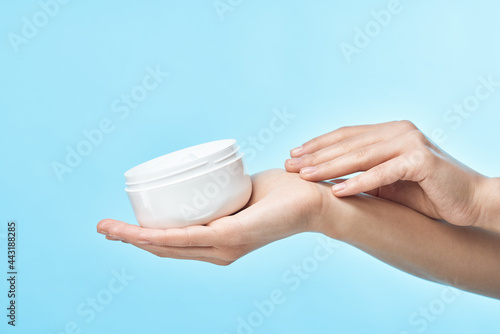 woman holding a jar of cream close-up dermatology skin care