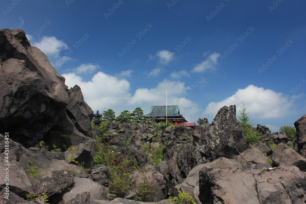 Naklejka premium 夏の北軽井沢。鬼押し出し園。溶岩の中に見える浅間山観音堂。