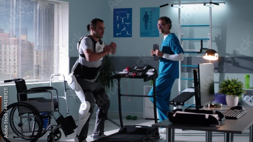 Wallpaper Mural Doctor showing moves to man in exoskeleton Torontodigital.ca