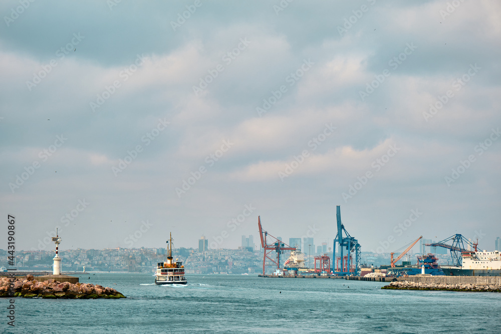 04.03.2021.istanbul, Turkey. Overcast and rainy day in istanbul bosphorus and transportation ship and pedestrian ferry and istanbul city and haydarpasa harbor and cranes background. 04.03.2021.istanbul, Turkey. Overcast and rainy day in istanbul bosphorus and transportation ship and pedestrian ferry and istanbul city and haydarpasa harbor and cranes background.