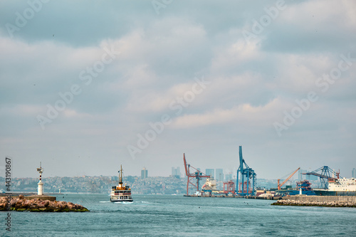 04.03.2021.istanbul, Turkey. Overcast and rainy day in istanbul bosphorus and transportation ship and pedestrian ferry and istanbul city and haydarpasa harbor and cranes background.