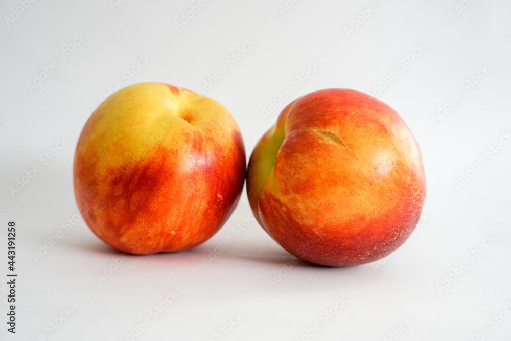 Side view of two nectarines on white background Side view of two nectarines on white background