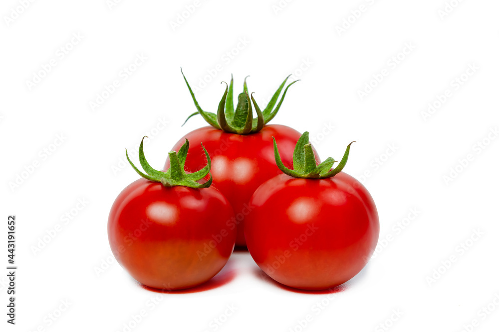 Three red fresh tomatoes on a white isolated background. Vegetarian food concept. Three red fresh tomatoes on a white isolated background. Vegetarian food concept.