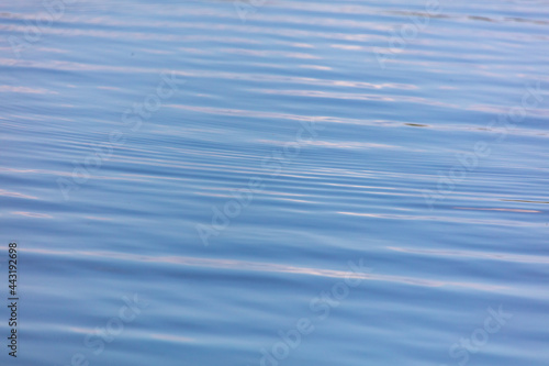 The smooth surface of the water in the lake as an abstract background.