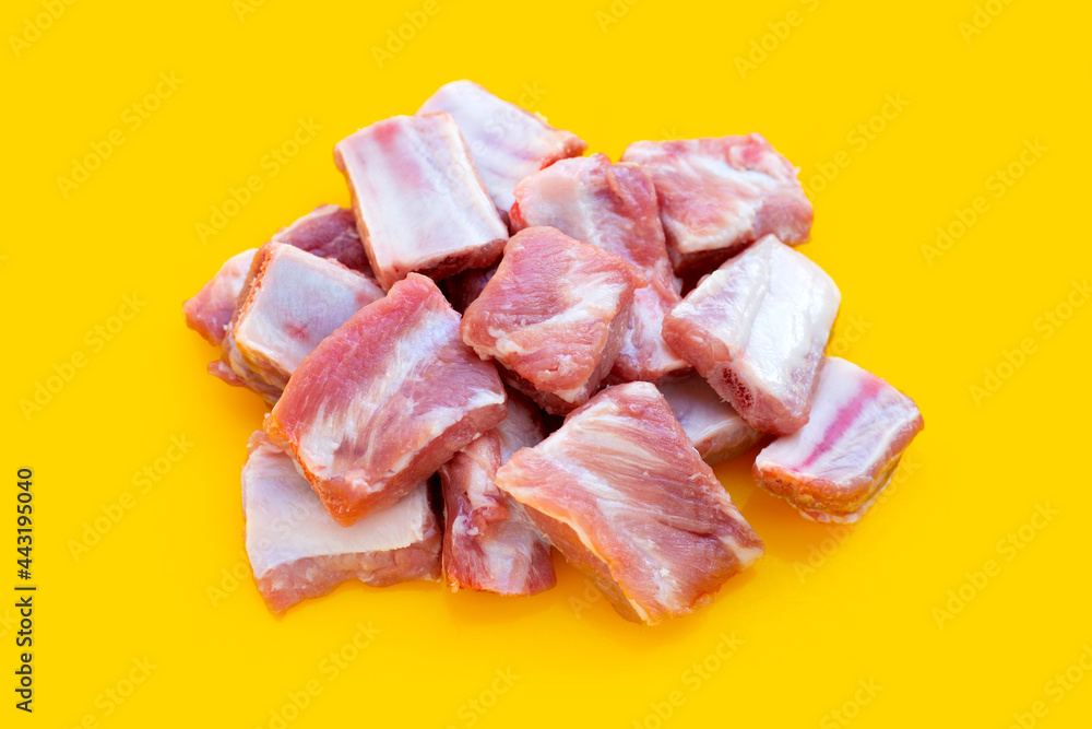 iRaw pork ribs on yellow background iRaw pork ribs on yellow background