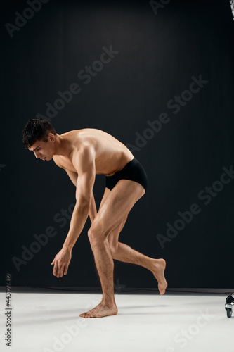 bodybuilder nude muscular body in black panties posing Studio