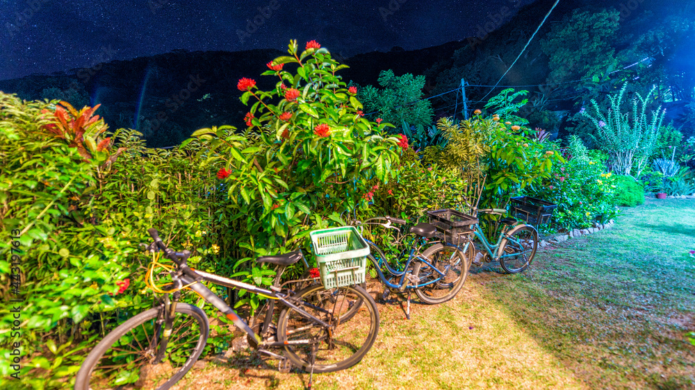 Parked bikes at night in La Digue - Seychelels