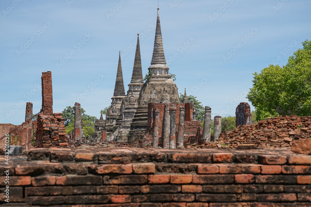 Fototapeta premium view to Wat Phra Si Sanphet temple in Ayutthaya historical park and temple bricks wall ruins remains, Ayutthaya, Thailand that the destination attractive tourists both Thai and foreigners