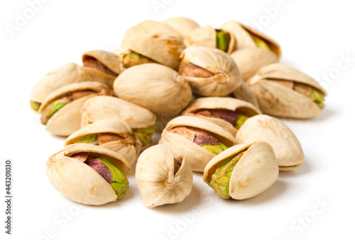 heap of roasted pistachios isolated on white background