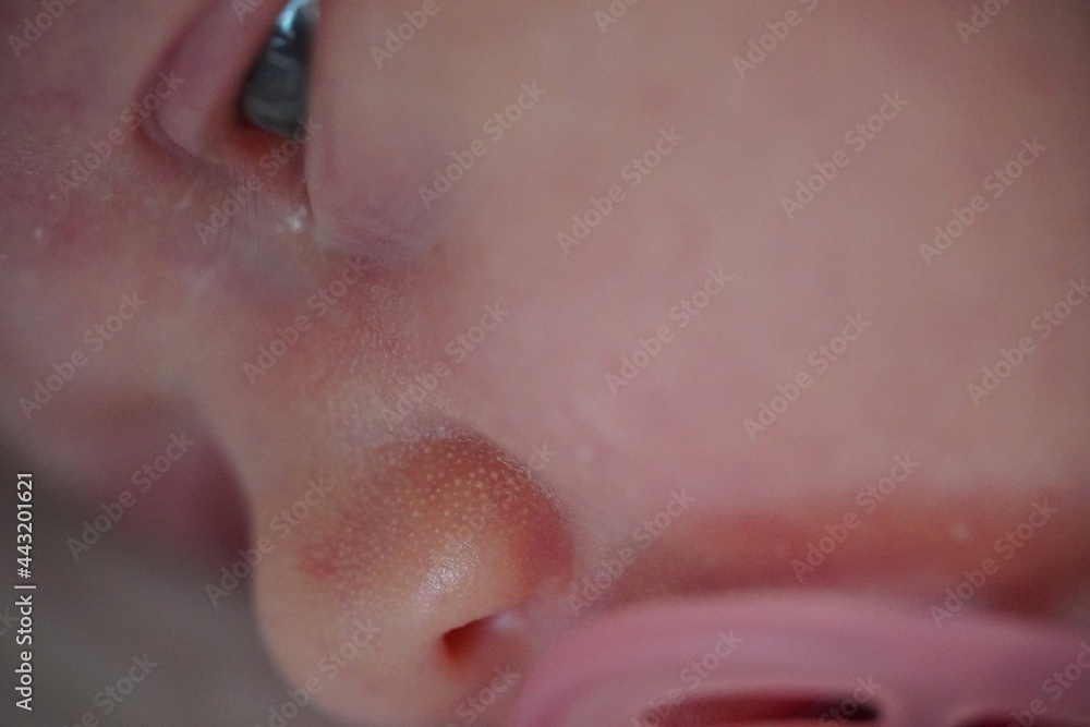 Fototapeta premium Newborn baby face. Open eyes. With pink Pacifier. close up view macro closeup. High quality photo