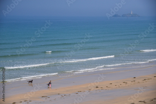 people walking dogs on the beach Hayle Cornwall 