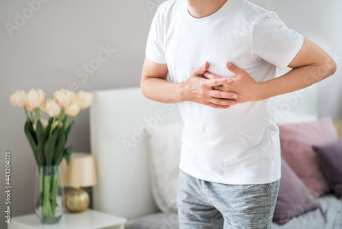 Fotografie Heart attack, man with chest pain suffering at home