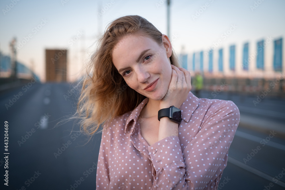 Portrait of a beautiful happy girl of European appearance in a retro dress stands on a drawbridge on the road. Portrait of a beautiful happy girl of European appearance in a retro dress stands on a drawbridge on the road.