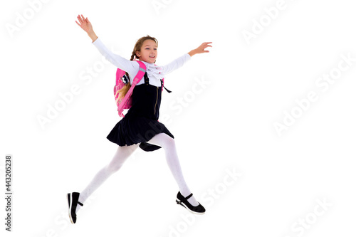 Happy schoolgirl running with backpack