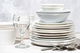 tableware, cutlery and glasses on a white table, closeup