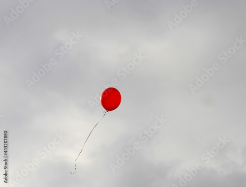 balloon that has escaped to freedom soars in the stormy sky
