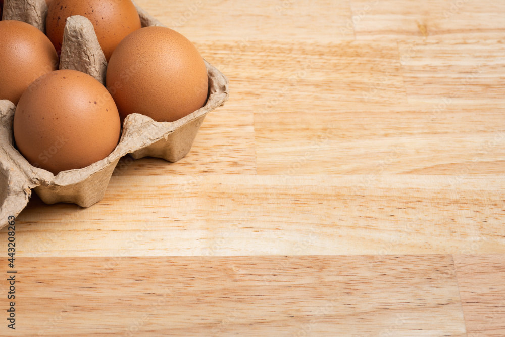 Chicken eggs in carton box on wooden table. Chicken eggs in carton box on wooden table.