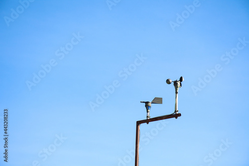 Anemometer in Meteorological weather station with blue sky background.