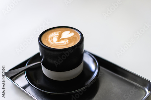 Cup of coffee with heart shape latte art.