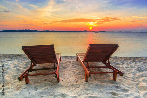 Lounge chairs sunset on the beach © Dwi