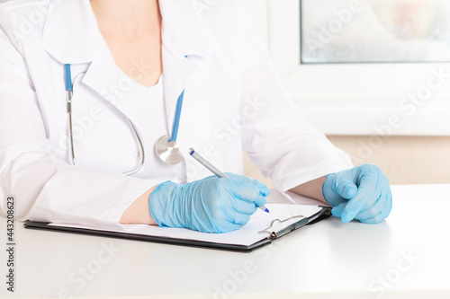 doctor's hands with a pen in the medical office in the clinic
