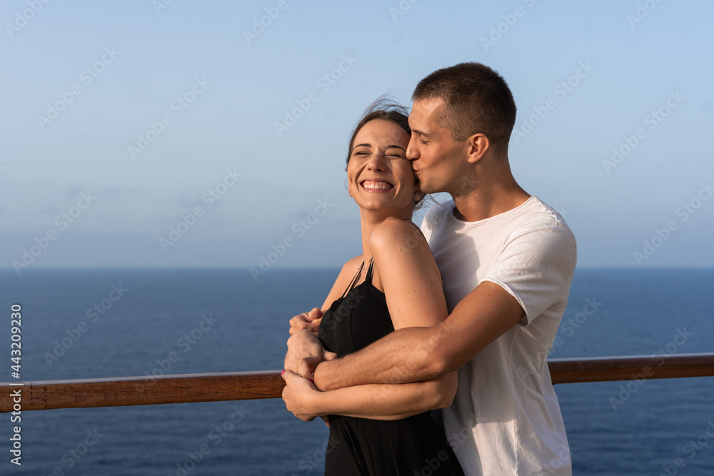 Young couple in love enjoying their honeymoon trip on a cruise ship