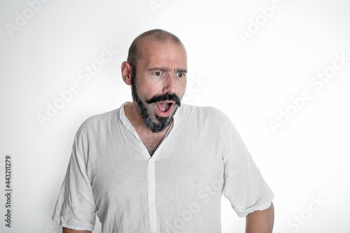 Caucasian 40 year old man making surprised expression on white isolated background