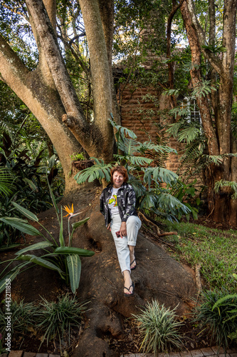 woman tourist posing in tropical park 