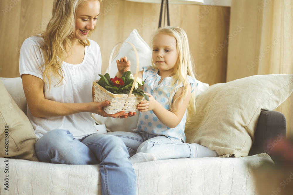 Happy mother day. Child daughter congratulates mom and gives her postcard with heart drawing. Family and childhood concepts