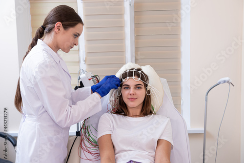 Patient brain testing using encephalography at medical center photo