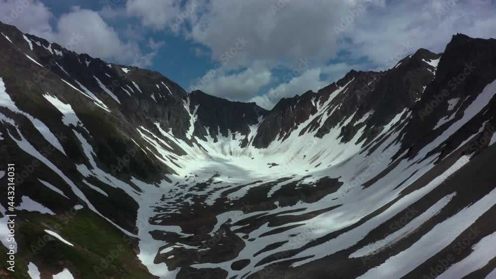 custom made wallpaper toronto digitalAerial view of mountain chain on Kamchatka peninsula. Drone 4k footage, dramatic aerial view. Snowy mountains in July 2021. Clouds moving fast
