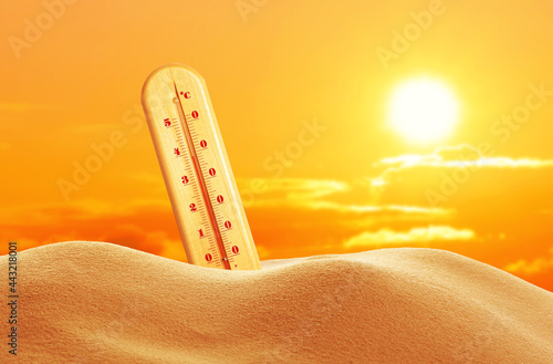 Weather thermometer with high temperature outdoors on hot sunny day. Heat stroke warning photo