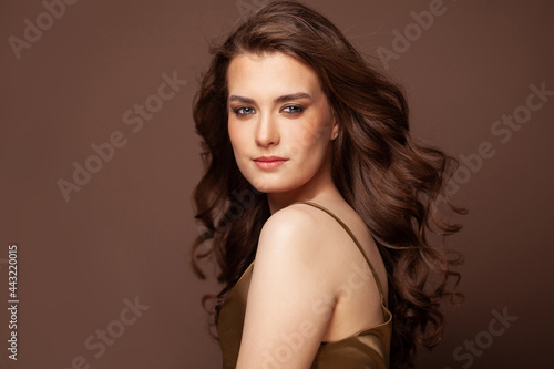 Portrait of pretty woman with dark hair, blue eyes, natural skin. Beautiful model smiling