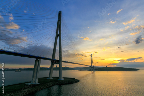 Fototapeta Naklejka Na Ścianę i Meble -  Russian bridge across the Eastern Bosphorus Strait in Vladivostok. Russian bridge to the Russky island against the background of a bright dawn.