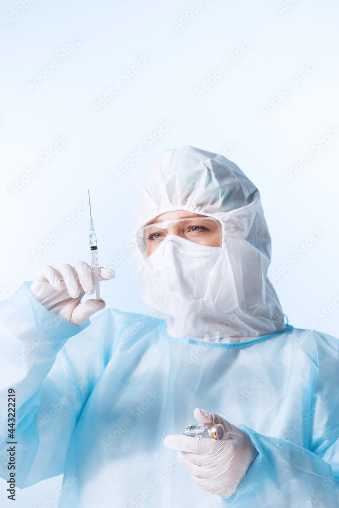 Naklejka premium Close up view of doctor with the syringe of covid vaccine on blue back