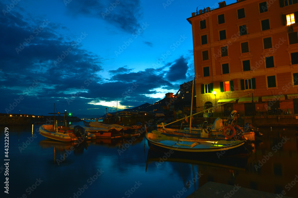incredible view of the small port of Camogli in the evening, lights, colors and reflections on the sea create a magical atmosphere