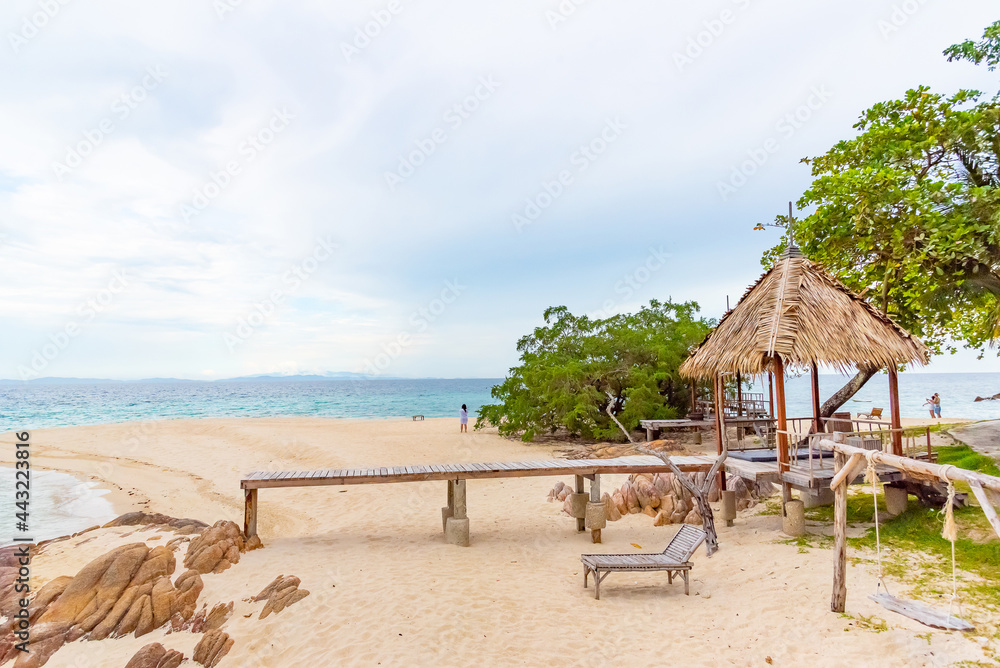 Nature in twilight period which including of sunrise over the sea and the nice beach. Summer beach with blue water and purple sky at the sunset.	
