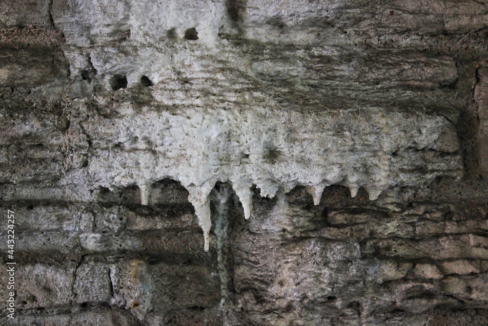 Drippy minerals hanging from the limestone. Drippy minerals hanging from the limestone.