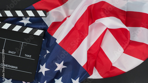 Fototapeta Naklejka Na Ścianę i Meble -  Black Clapper board or movie slate and Flag of the United States of America (USA.) on black background.