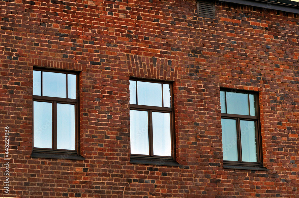 Obraz premium Three windows in a brick wall