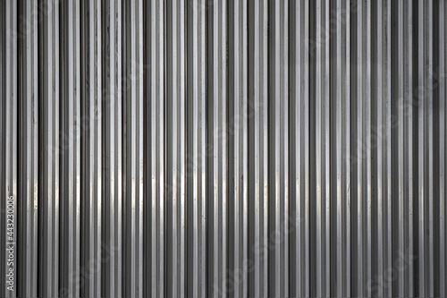 Background from unpainted corrugated metal. Vertical stripes.