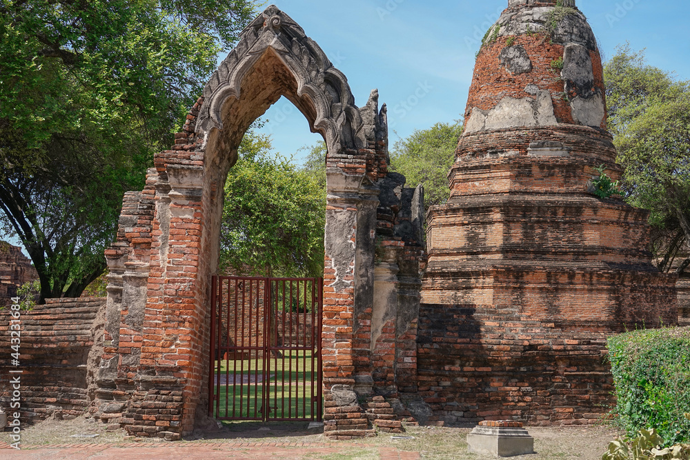 view to the wall and door into stupa and ruins of temple, old Siam capital Ayutthaya,the historical about religious architecture of Thailand that attractive the tourist both Thai and foreigner