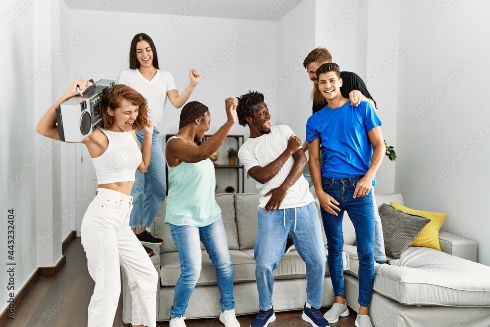 Group of young friends smiling happy and dancing at home. Group of young friends smiling happy and dancing at home.