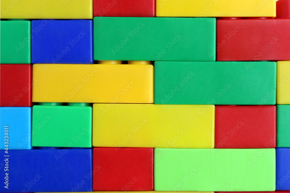 Texture of stacked bright, colorful constructor parts