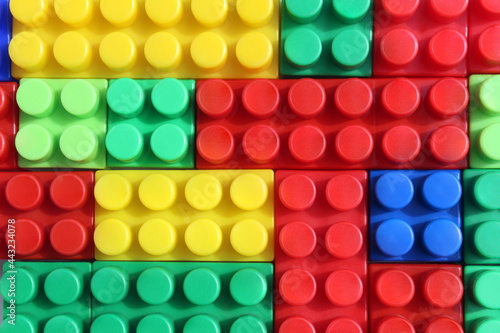 Texture of stacked bright, colorful constructor parts