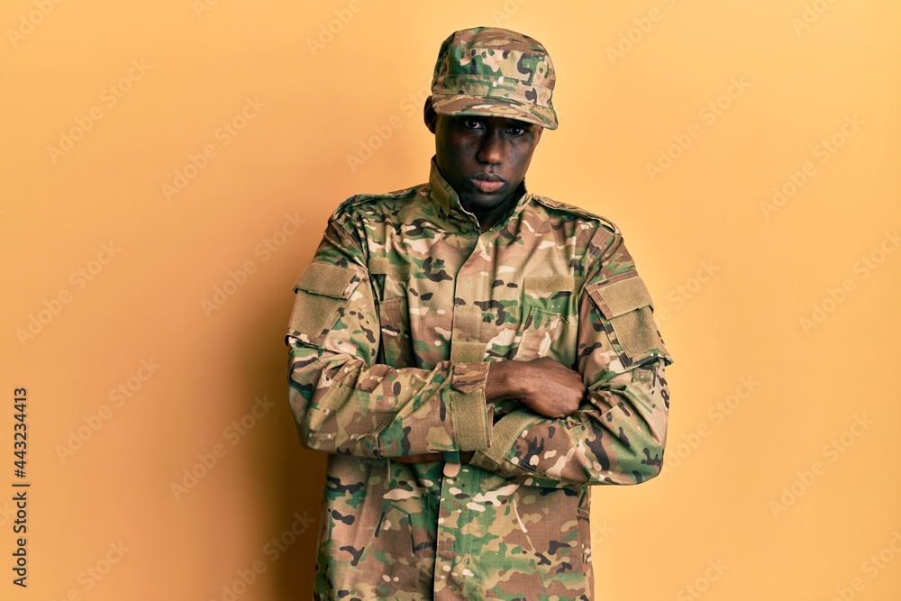 Young african american man wearing army uniform skeptic and nervous, disapproving expression on face with crossed arms. negative person. Young african american man wearing army uniform skeptic and nervous, disapproving expression on face with crossed arms. negative person.